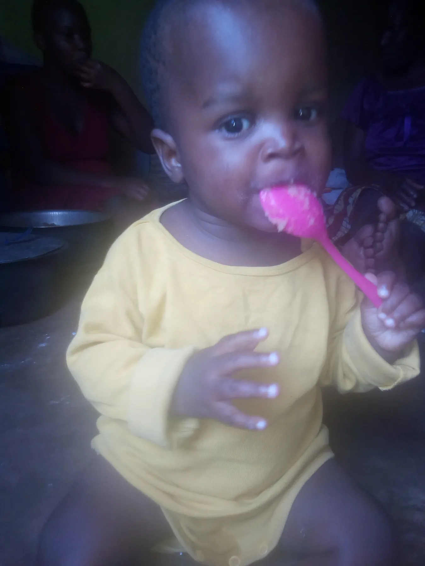 A young child holding a spoon