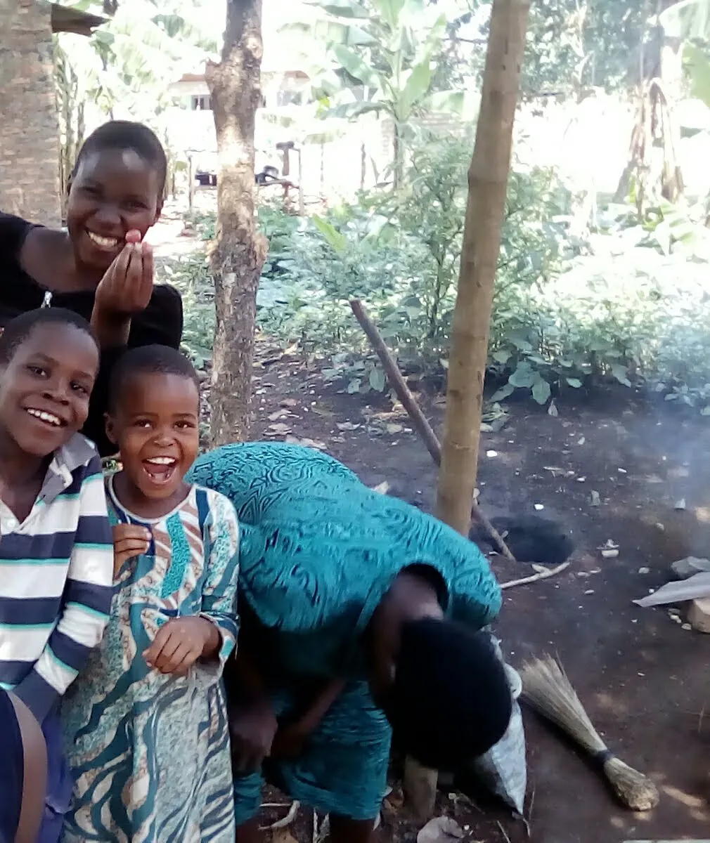 A caregiver and children together outside