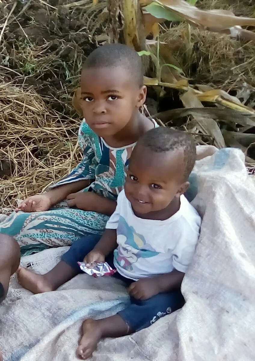 Two children sitting together outdoors