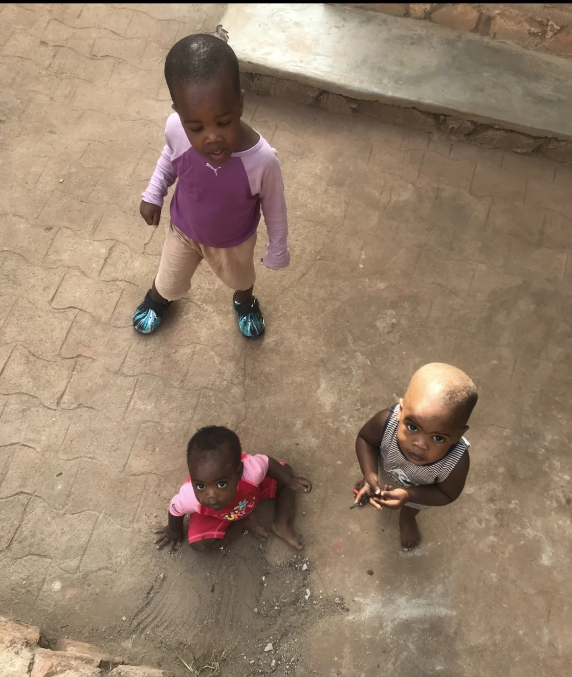 Children sitting together in a courtyard