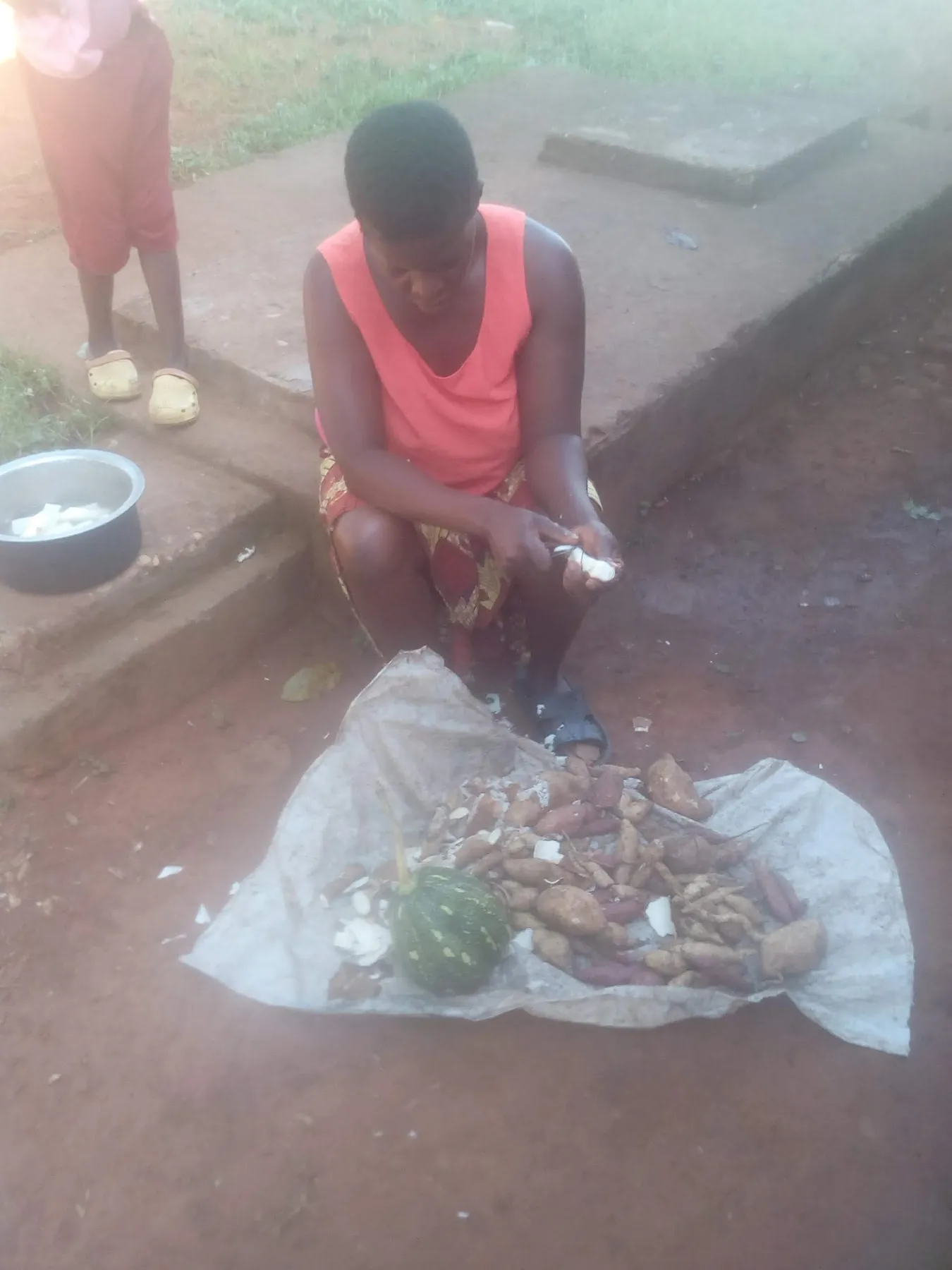 A person preparing root vegetables outdoors